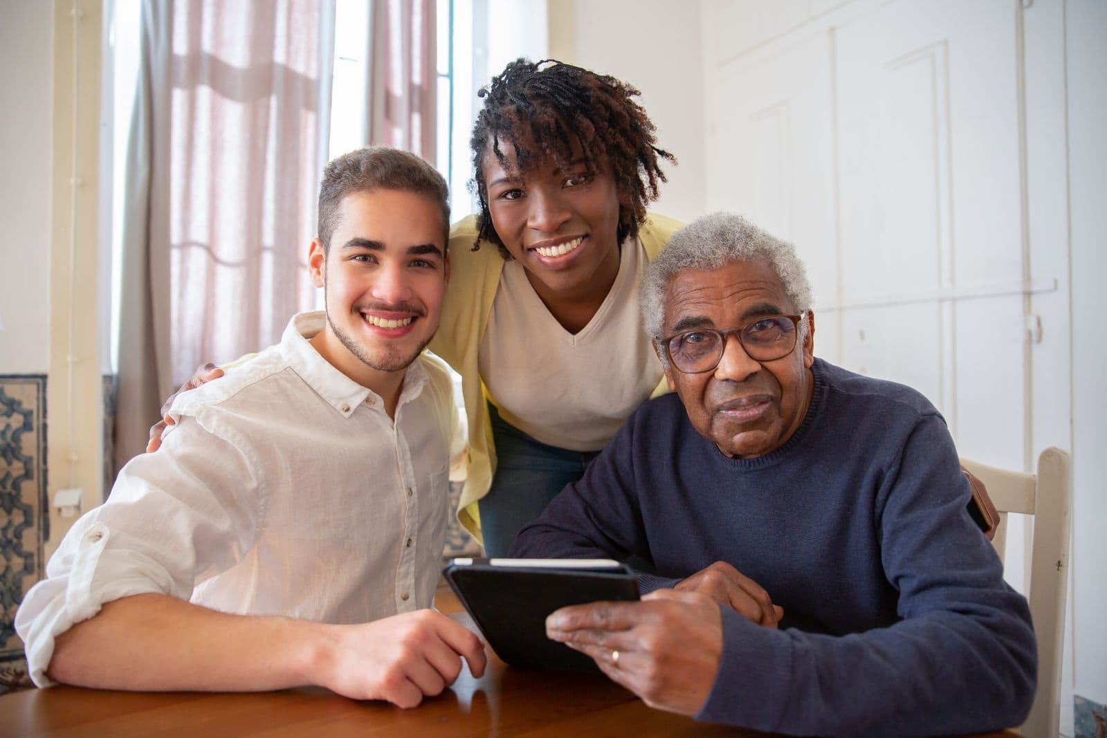 Adult child sitting with an aging parent at home during a care conversation