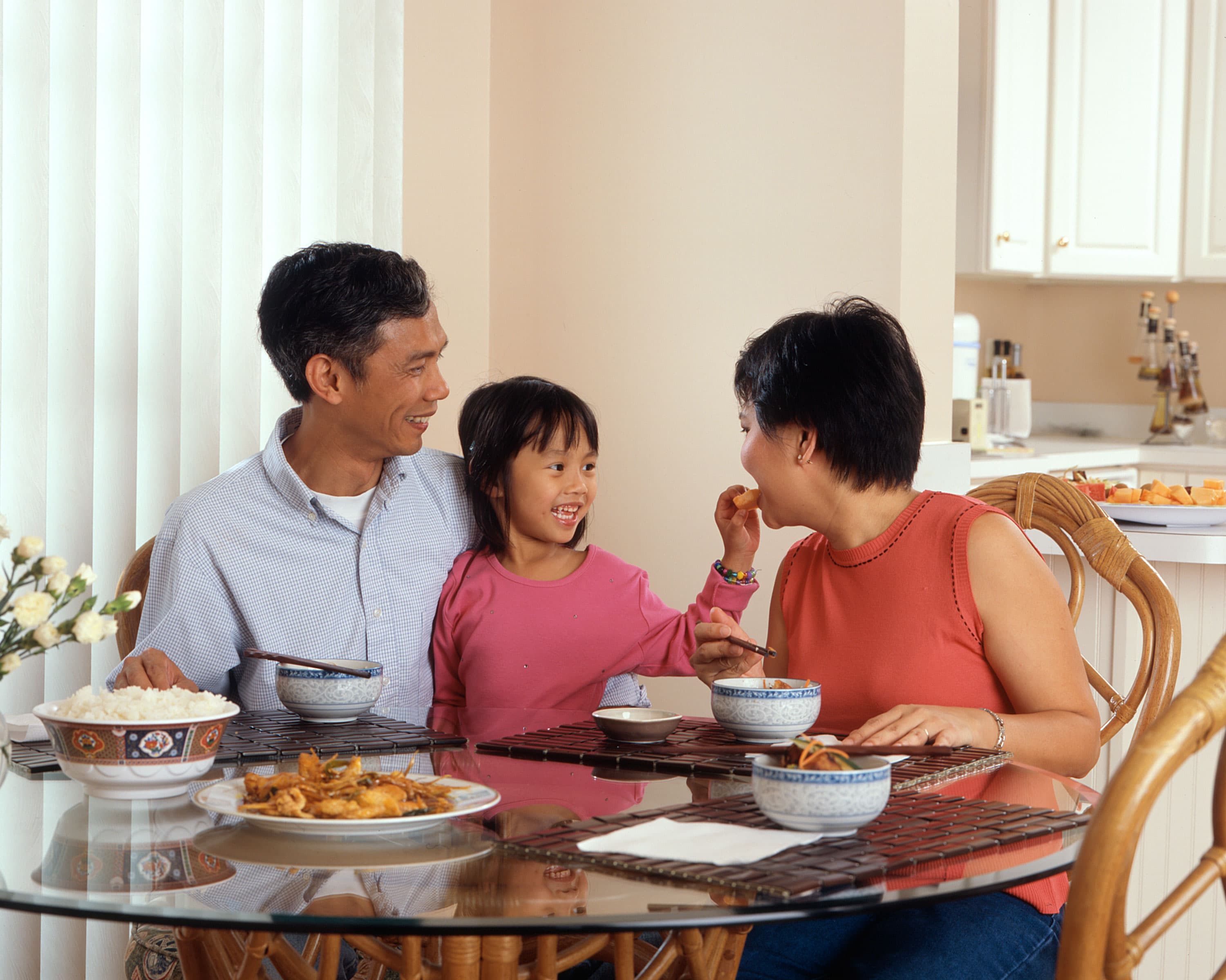 Asian family sharing a meal around a dining table