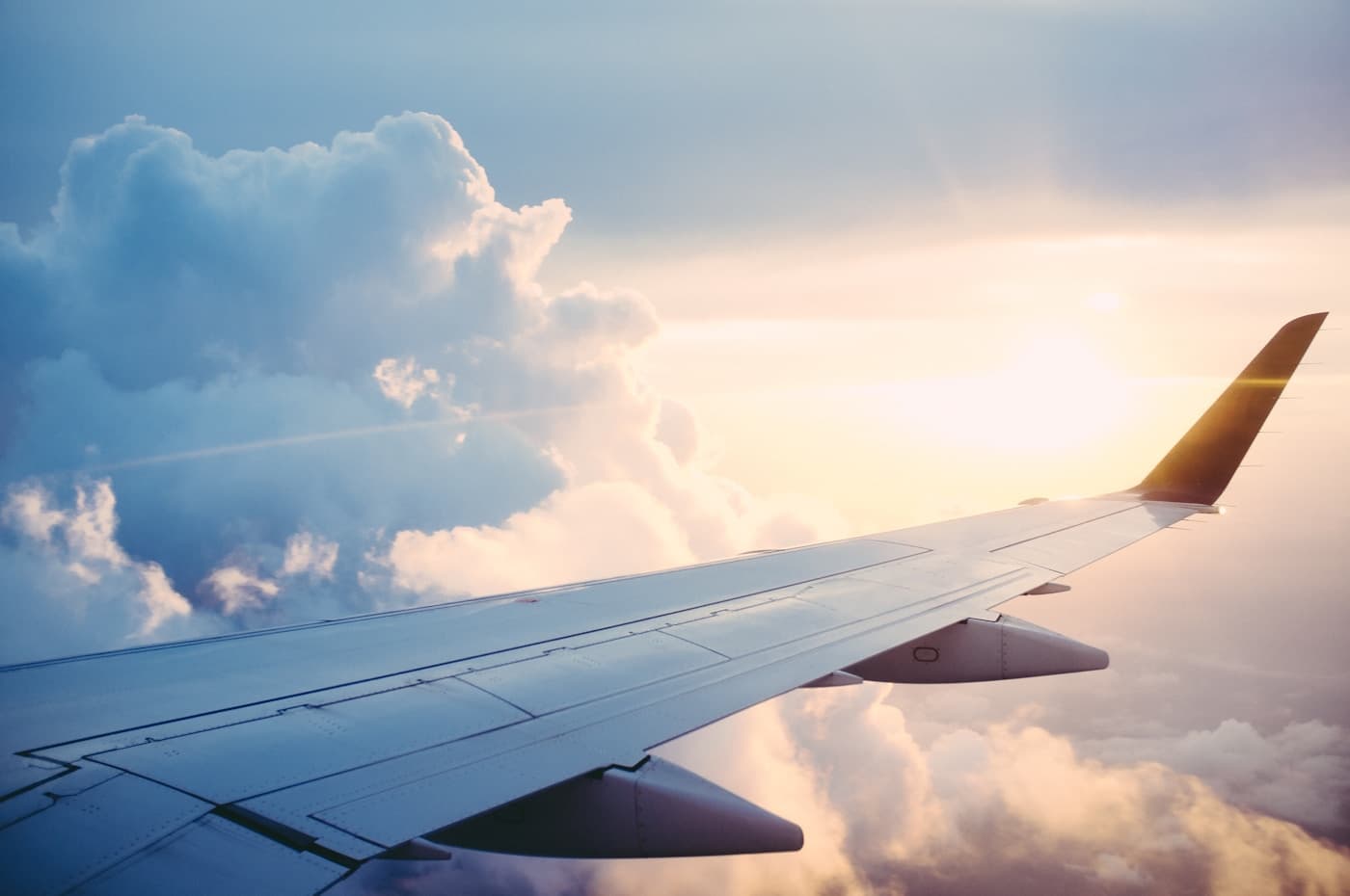 Open passport pages beside a window seat on an airplane