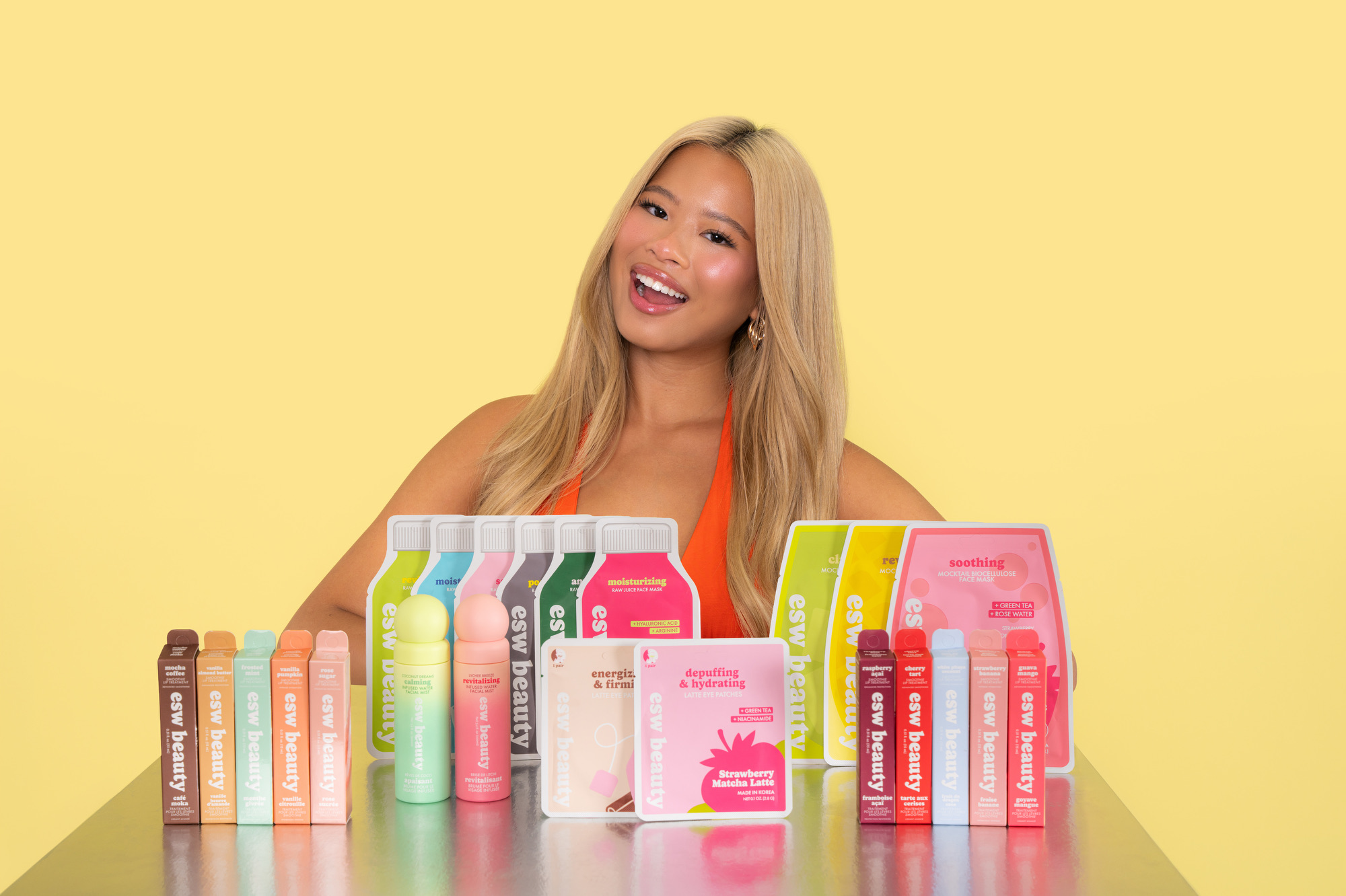 Katie Fang posing with ESW Beauty sheet masks, mists, and eye patches