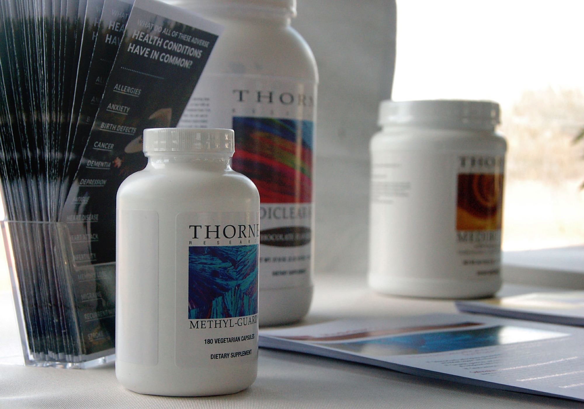 Thorne Research Methyl-Guard and other supplement bottles on a display table