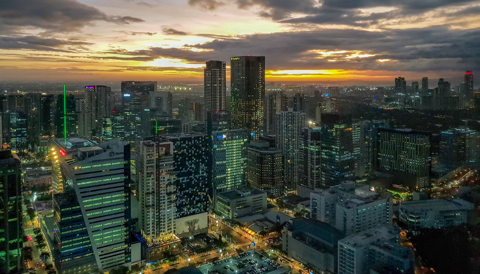 Bonifacio Global City and Makati skylines at sunset in Metro Manila