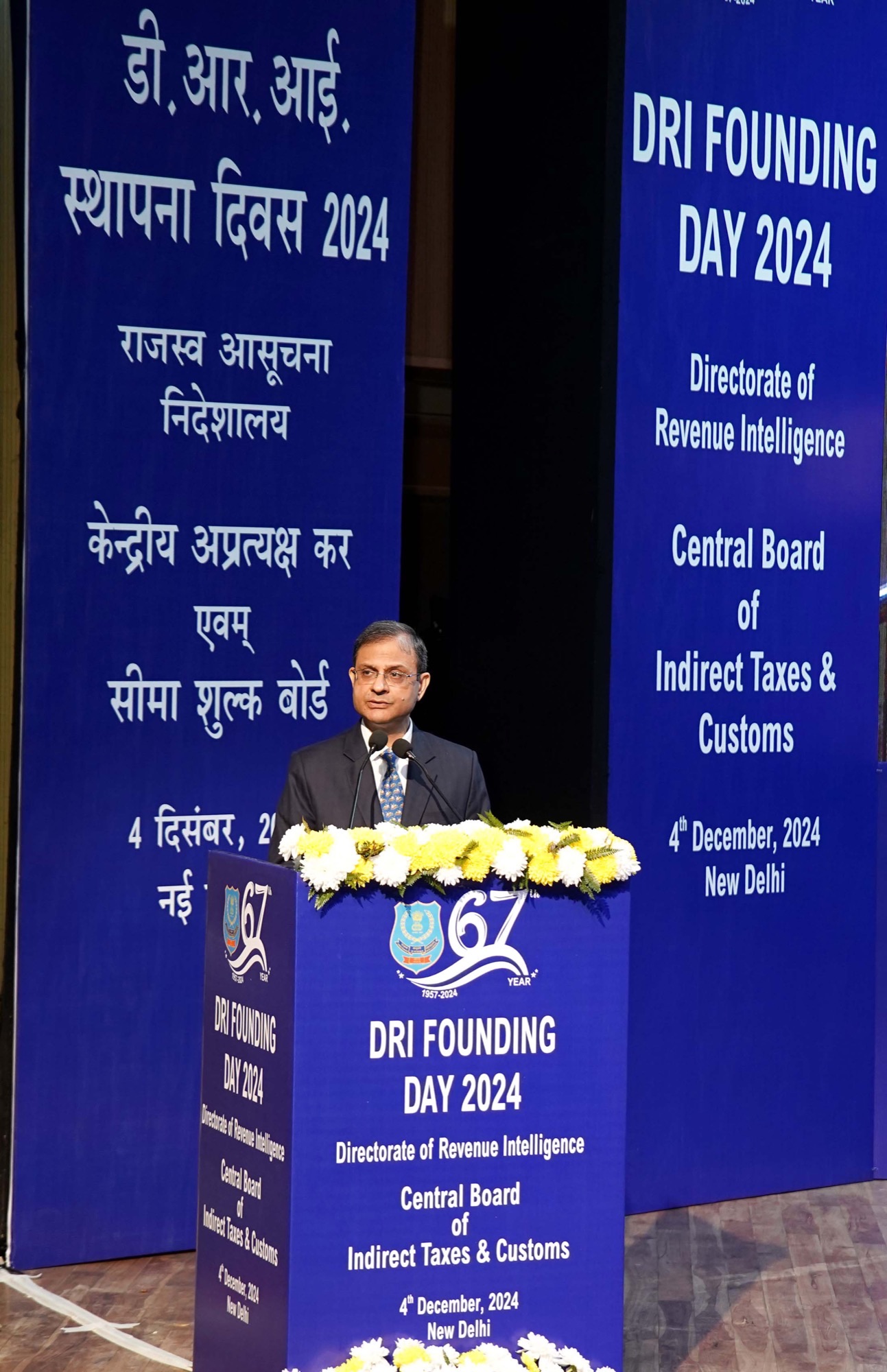 RBI Governor Sanjay Malhotra speaking at a podium in New Delhi