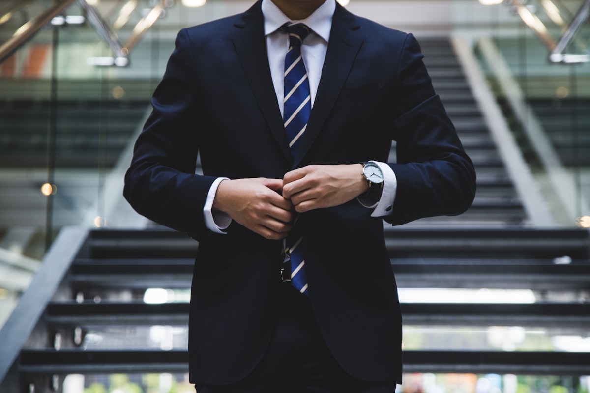 Business professional in a suit reviewing documents at a desk